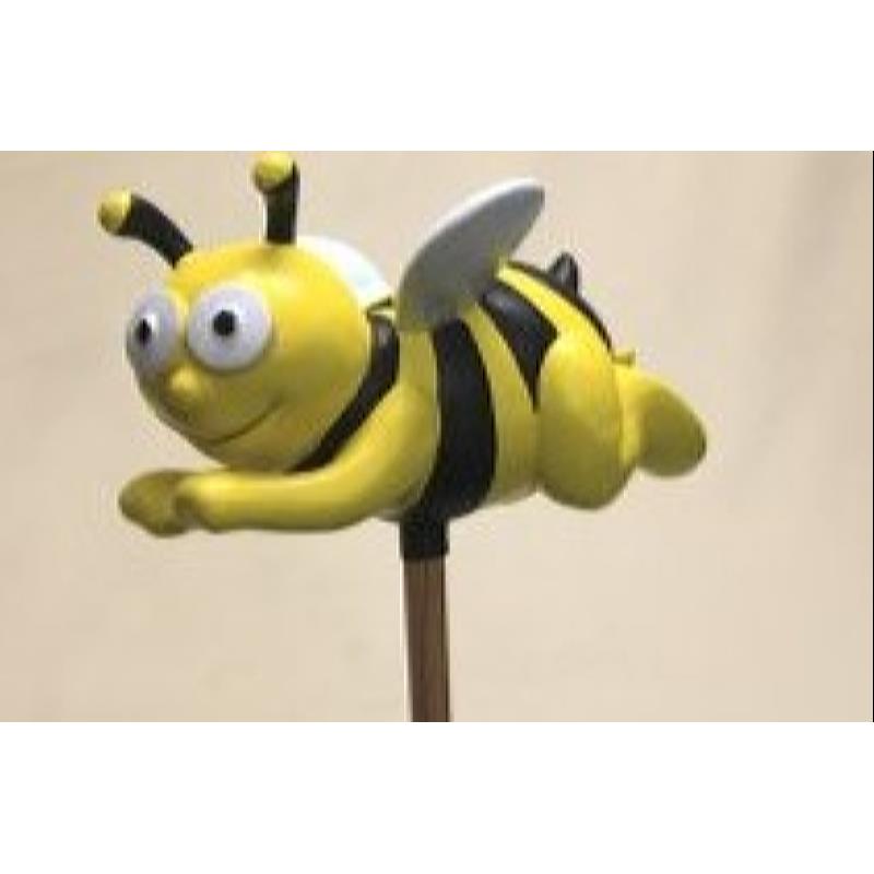 Bee flying, on a stick